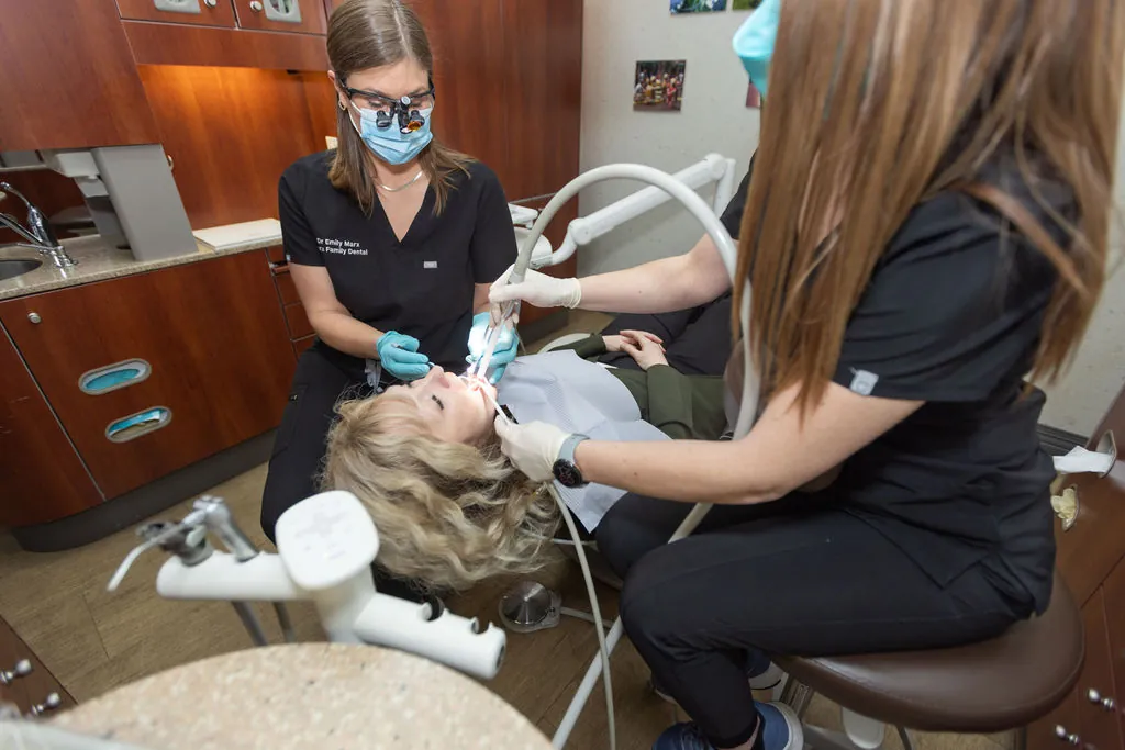 A dentist and assistant treating a patient