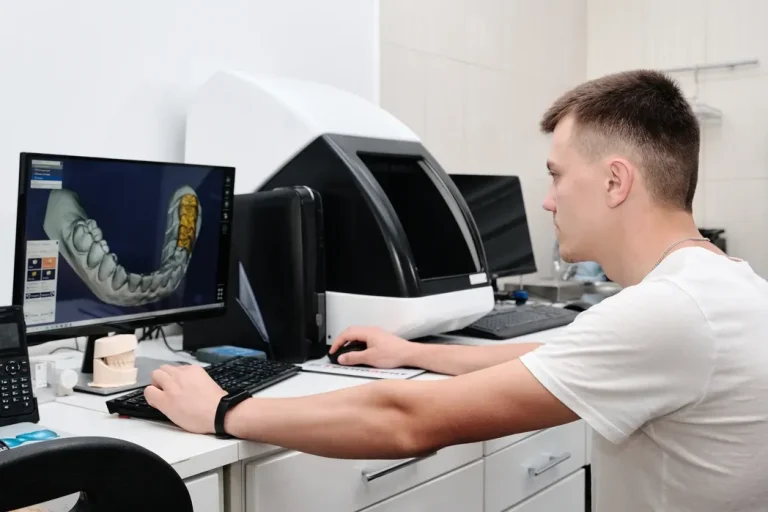 A technician designing a crown on a CAD screen