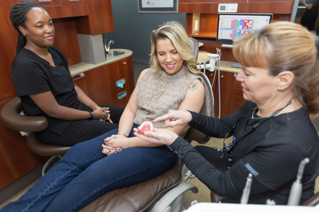 Team members talking with a patient about her treatment